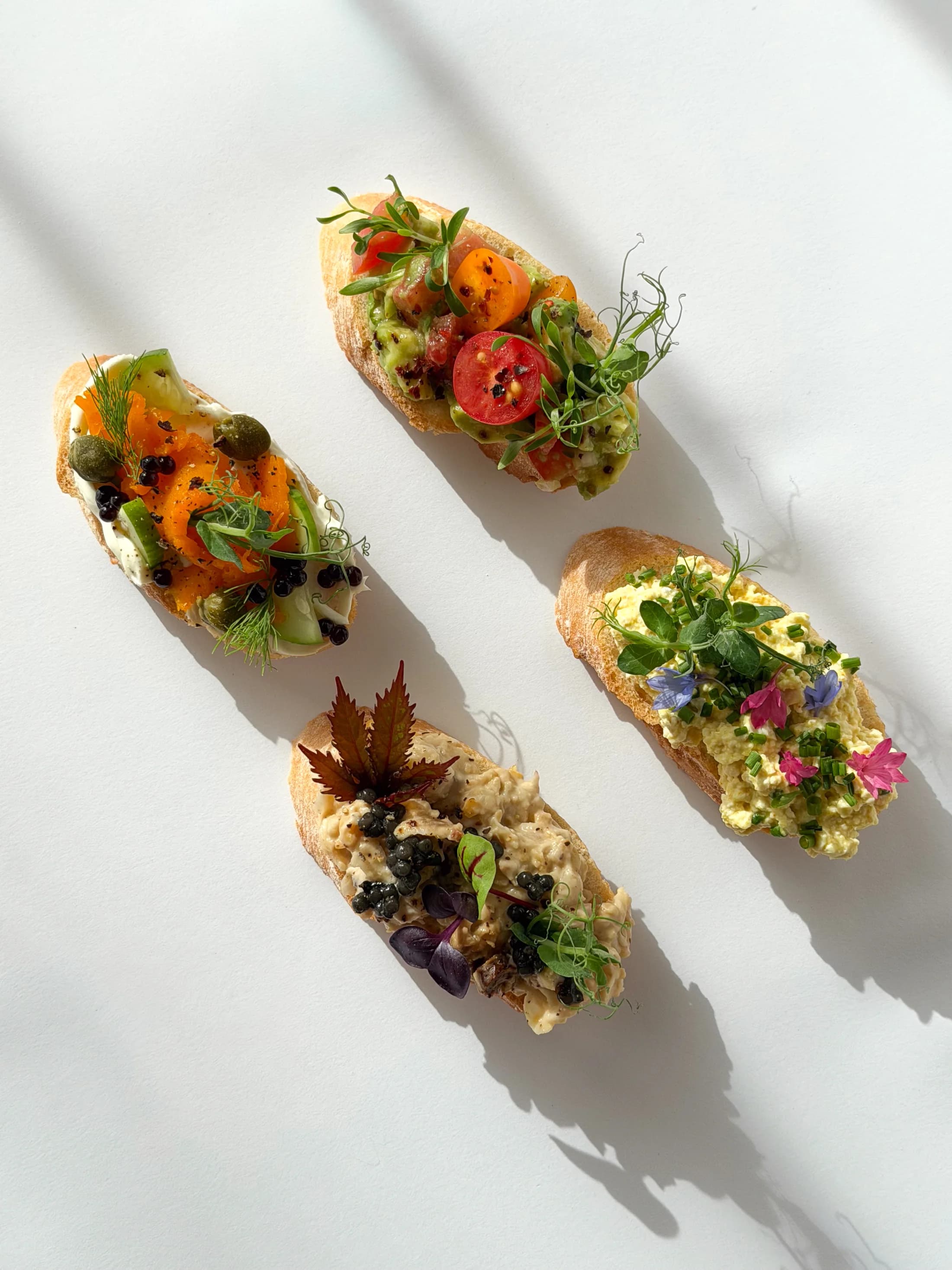 Colorful current Canapés baguette canapés with vegetables, herbs and edible flowers.