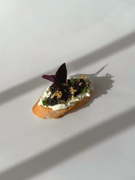 Beluga caviar canapé with edible gold leaf.